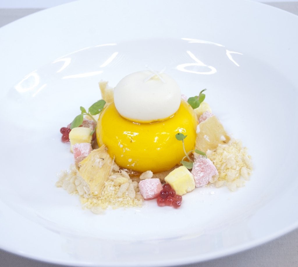 Mango glazed coconut mousse centred with caramel, vanilla, pineapple cake on a macadamia and white chocolate sable