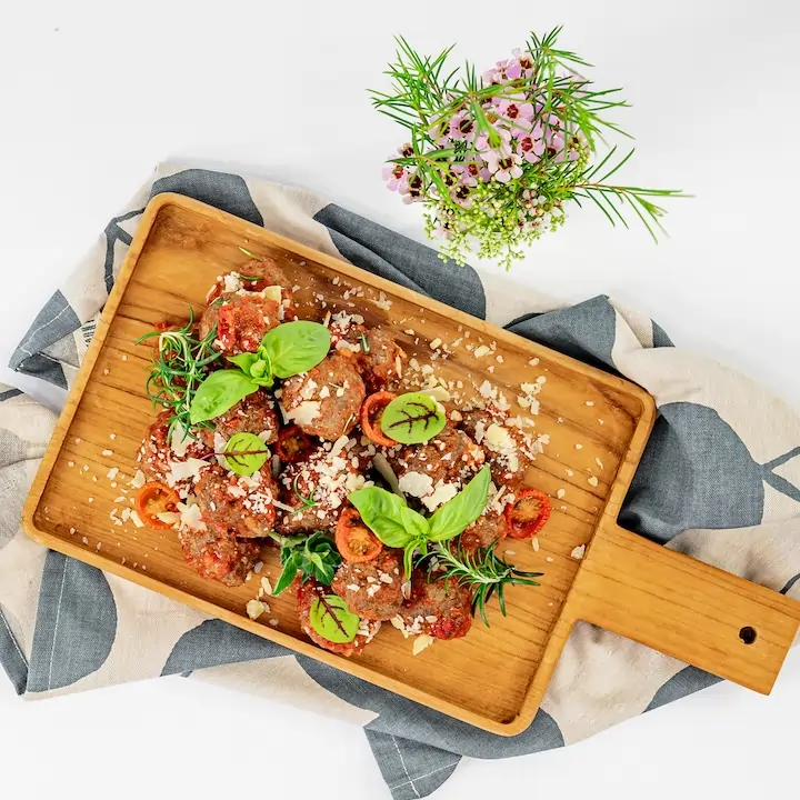Nonna’s meatballs, rich tomato glaze, shaved parmesan, roasted cherry tomatoes