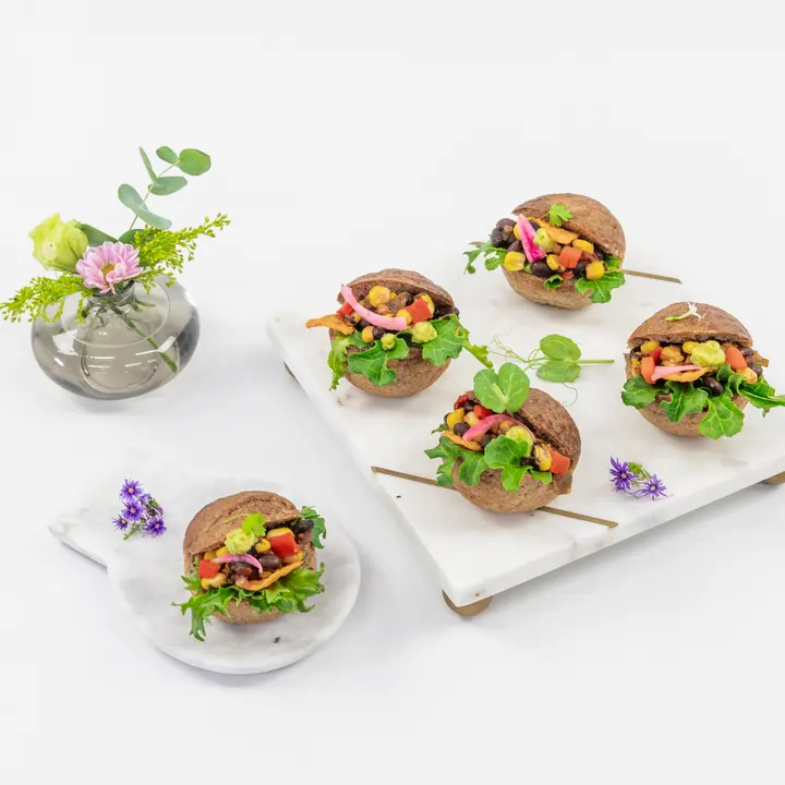 Mexican black bean slider, charred corn salsa, guacamole, tomato, lettuce and crunchy corn chips