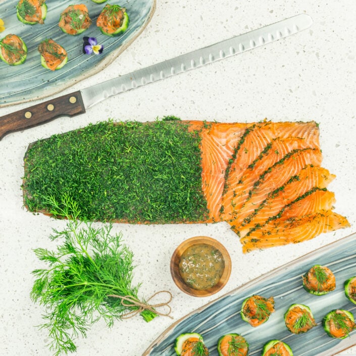 Gravlax - Dill cured salmon on cucumber disc, mustard dill dressing