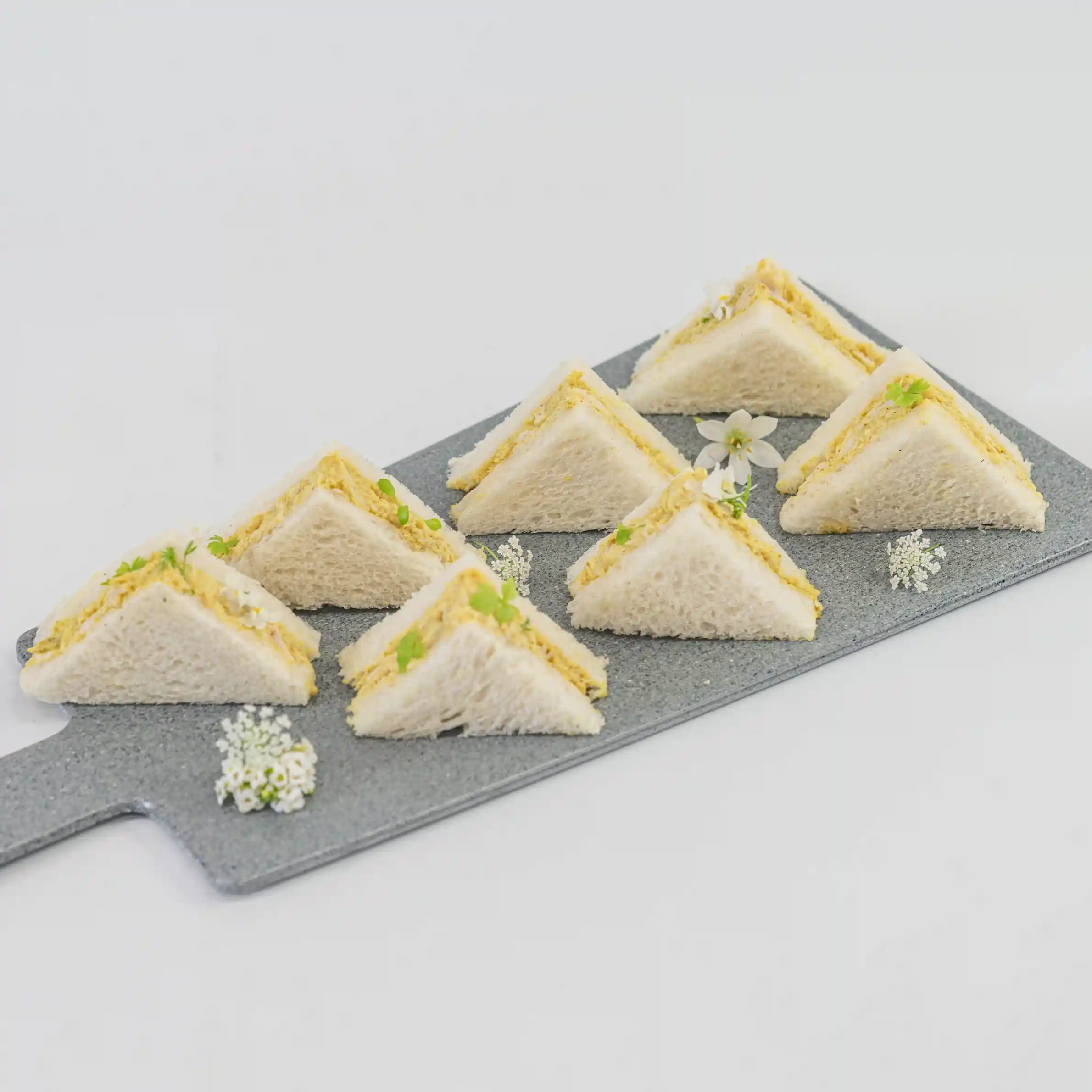 Coronation chicken mini sandwich, mango compote, baby herbs, mild curry mayonnaise