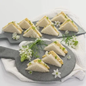 Coronation chicken mini sandwich, mango compote, baby herbs, mild curry mayonnaise