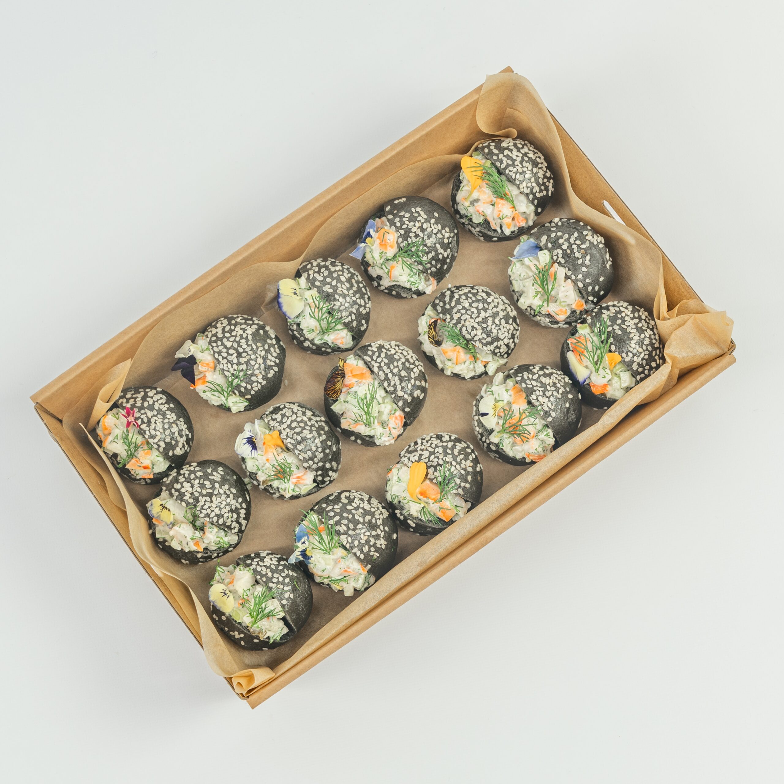 Australian prawn, citrus and dill remoulade, charcoal brioche baby bun, edible blooms