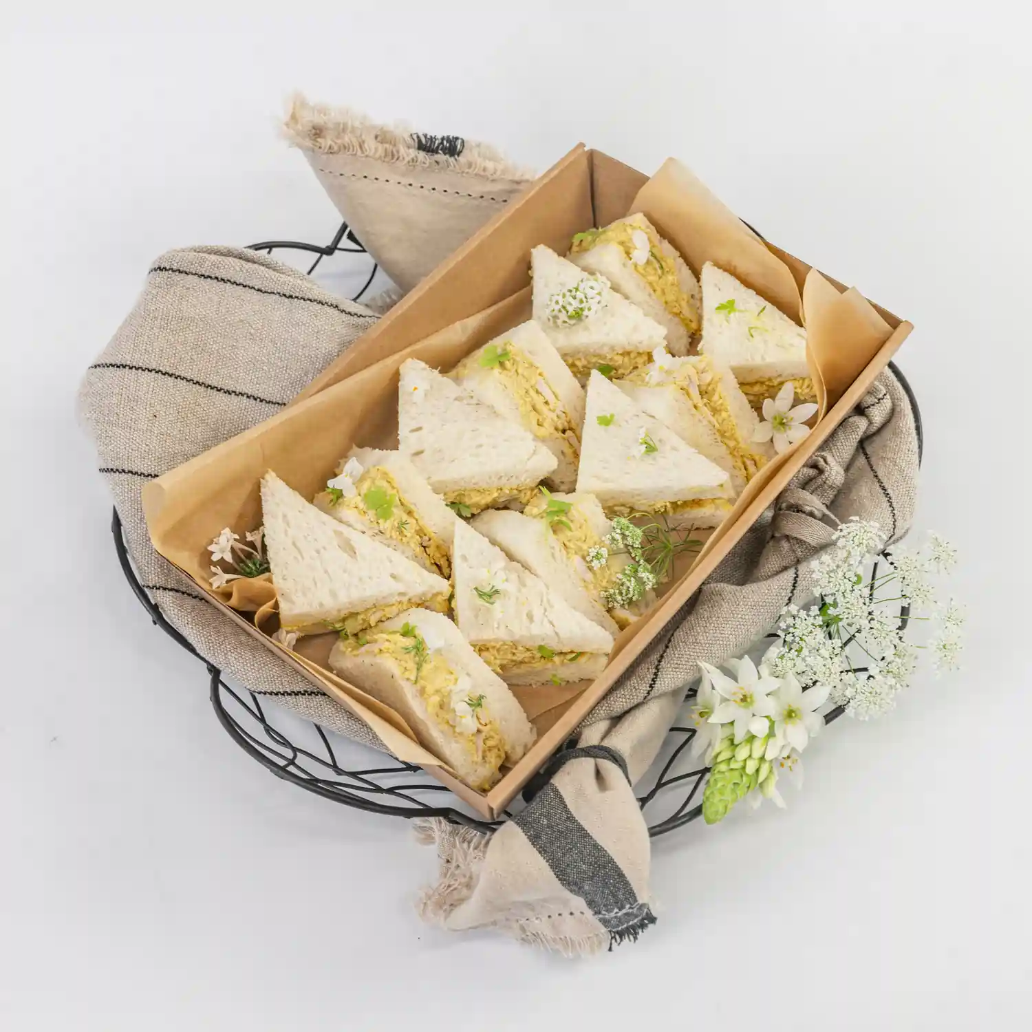 Coronation chicken mini sandwich, mango compote, baby herbs, mild curry mayonnaise