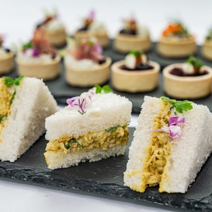 Coronation chicken mini sandwich, mango compote, baby herbs, mild curry mayonnaise