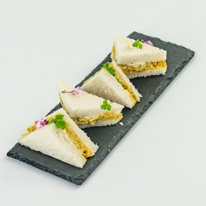 Coronation chicken mini sandwich, mango compote, baby herbs, mild curry mayonnaise