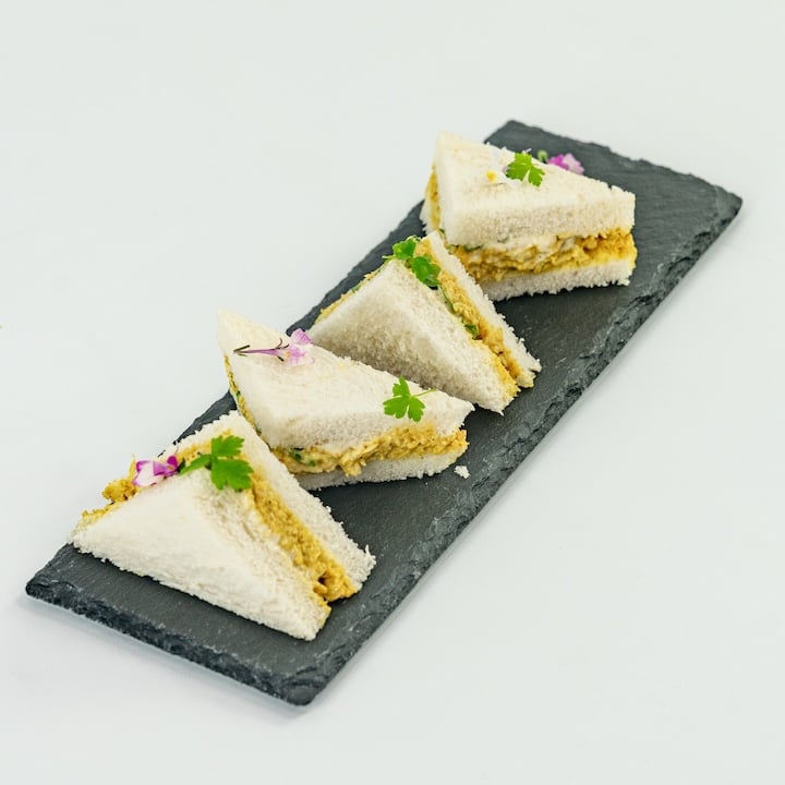 Coronation chicken mini sandwich, mango compote, baby herbs, mild curry mayonnaise