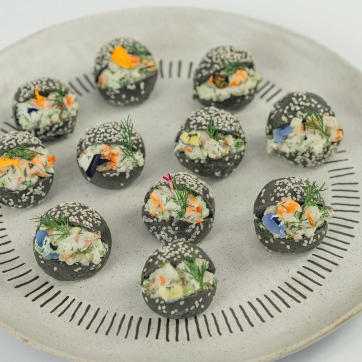 Australian prawn, citrus and dill remoulade, charcoal brioche baby bun, edible blooms
