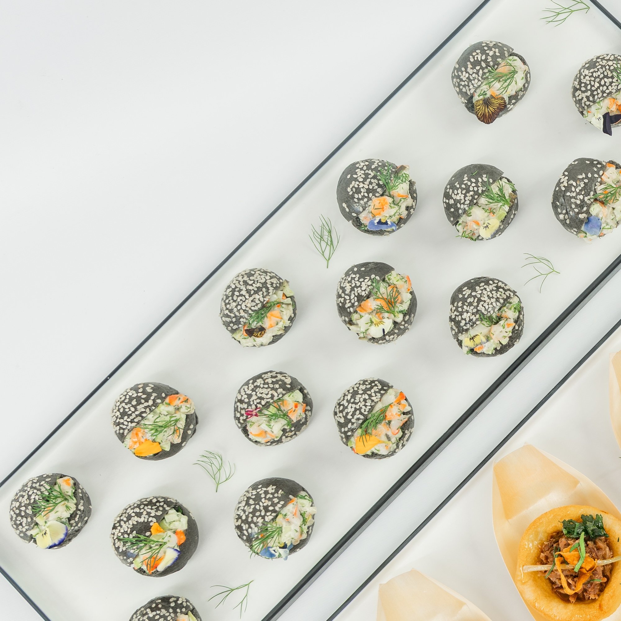 Australian prawn, citrus and dill remoulade, charcoal brioche baby bun, edible blooms