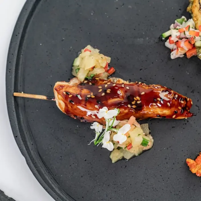 Teriyaki-glazed chicken skewer, toasted sesame, ginger-pineapple relish
