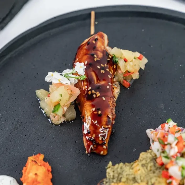 Teriyaki-glazed chicken skewer, toasted sesame, ginger-pineapple relish