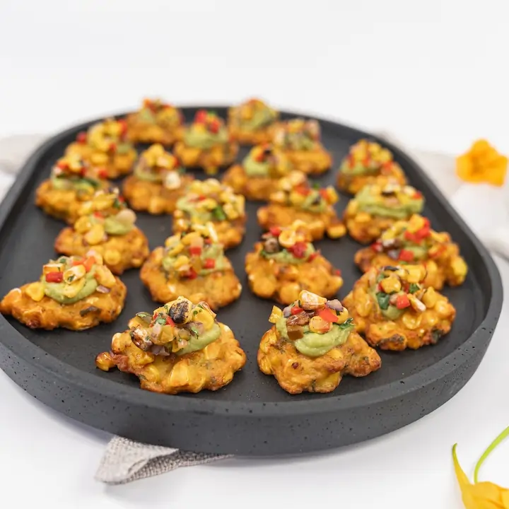 Charred sweetcorn fritter, avocado crema & pineapple corn salsa