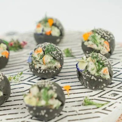 Australian prawn, citrus and dill remoulade, charcoal brioche baby bun, edible blooms