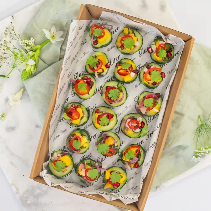 Mango, lychee & pomegranate salsa on cucumber disc with pickled chilli