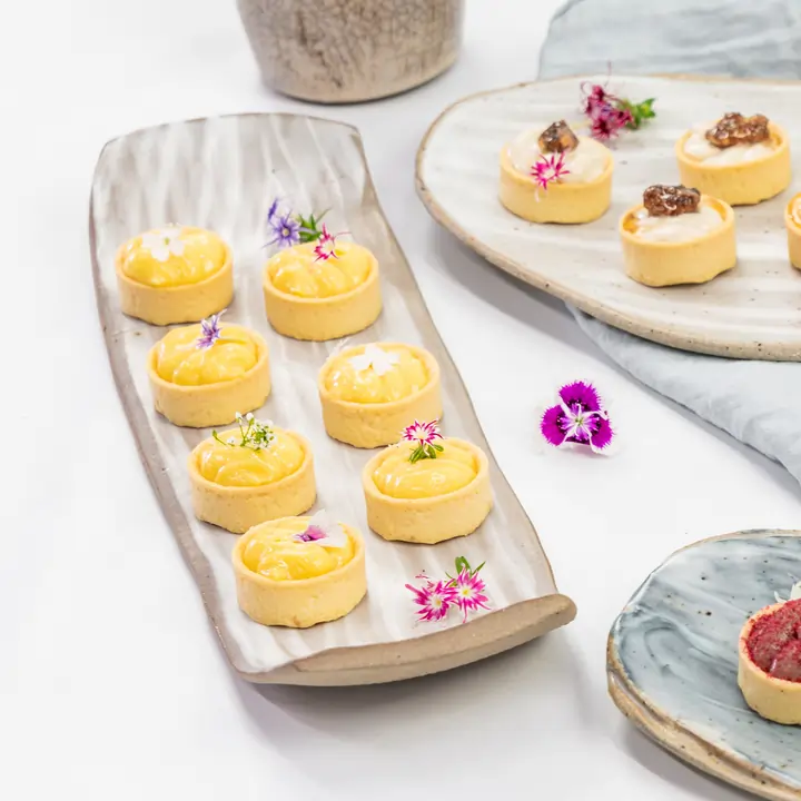 Petite lemon curd tartlet, edible bloom